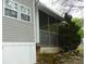 Exterior detail of home with gray vinyl siding and an enclosed porch at 124 Hummingbird Cir, New London, NC 28127