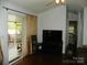 Open living room with access to a screened porch, enhanced by a TV for entertainment at 124 Hummingbird Cir, New London, NC 28127