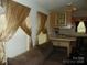 Living room showing open floor plan to kitchen with natural lighting and comfortable sofa at 124 Hummingbird Cir, New London, NC 28127