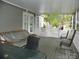 Large screened-in porch with a view of the yard and outdoor furniture at 124 Hummingbird Cir, New London, NC 28127