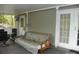 Spacious screened-in porch featuring a couch and French doors at 124 Hummingbird Cir, New London, NC 28127
