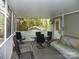 Screened-in porch with outdoor furniture and decor at 124 Hummingbird Cir, New London, NC 28127
