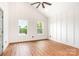 Bright bedroom with vaulted ceilings, wood-look floors, two windows, and modern ceiling fan at 1314 Eddie St, Gastonia, NC 28054