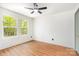 Bright bedroom featuring natural light from two windows, a ceiling fan, and wood floors at 1314 Eddie St, Gastonia, NC 28054