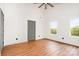 Bright bedroom with vaulted ceilings, wood-look floors, two windows, closet, and modern ceiling fan at 1314 Eddie St, Gastonia, NC 28054