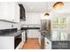 Close-up of a modern kitchen with stainless steel appliances, dark countertops, and custom cabinetry for ample storage at 1314 Eddie St, Gastonia, NC 28054