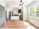 Bright, open kitchen featuring stainless steel appliances, modern cabinetry, pendant lighting, and a view into the living area at 1314 Eddie St, Gastonia, NC 28054