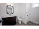 Bathroom features decorative mirror, toilet and dark vanity with light countertop at 139 Poplar Grove Rd, Mooresville, NC 28117