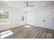 Sunlit bedroom with two windows, ceiling fan, and modern closet doors at 139 Poplar Grove Rd, Mooresville, NC 28117