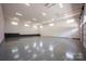 Large garage space featuring a sleek epoxy floor, high ceilings, and ample lighting at 139 Poplar Grove Rd, Mooresville, NC 28117