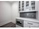 This kitchen features stainless steel microwave, gray backsplash, white countertops and glass cabinets at 139 Poplar Grove Rd, Mooresville, NC 28117