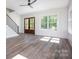 Bright open-concept living room with big windows and wood floors at 139 Poplar Grove Rd, Mooresville, NC 28117