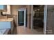 View of a tiled bathroom, showcasing a glass-enclosed shower, vanity with a sink, and mosaic tile accents at 1404 Oakdale Rd, Rock Hill, SC 29730