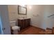 Cozy half bathroom featuring hardwood floors, a toilet, and a vanity at 1404 Oakdale Rd, Rock Hill, SC 29730