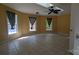 Spacious bedroom with a ceiling fan and a large window overlooking the lush outdoors at 1404 Oakdale Rd, Rock Hill, SC 29730