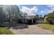 Spacious driveway leading to home with pergola covered porch; landscaped with mature trees at 1404 Oakdale Rd, Rock Hill, SC 29730