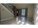 Bright living room with tile floors, a brick accent wall, and stairway leading to the second floor at 1404 Oakdale Rd, Rock Hill, SC 29730