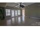 Living room featuring a ceiling fan, windows, and tiled floors, creating a bright atmosphere at 1404 Oakdale Rd, Rock Hill, SC 29730