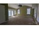 Spacious living room featuring green walls, carpet flooring, and many windows for lots of natural light at 1404 Oakdale Rd, Rock Hill, SC 29730