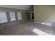 Large living room features green walls, carpet flooring, and three large windows at 1404 Oakdale Rd, Rock Hill, SC 29730