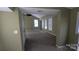 This large living room features green walls, carpet flooring, recessed lights and several large windows at 1404 Oakdale Rd, Rock Hill, SC 29730