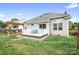 Backyard featuring deck, pergola with seating, grassy area, and tidy landscaping at 141 Rose St, Mooresville, NC 28117