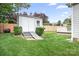 Backyard with a white storage shed and a wooden fence surrounding the well-maintained lawn at 141 Rose St, Mooresville, NC 28117