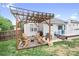 Outdoor deck with pergola, seating area, grill, and landscaped yard provides a perfect space for relaxation at 141 Rose St, Mooresville, NC 28117
