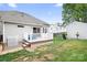 Backyard featuring a deck with white railing, a well-maintained lawn, and a detached garage at 141 Rose St, Mooresville, NC 28117
