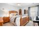 Bedroom with a wooden bed frame, bedside tables, stylish bedding, and natural light from the window at 141 Rose St, Mooresville, NC 28117