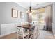 Elegant dining room with natural light, chandelier lighting and a neutral color palette at 141 Rose St, Mooresville, NC 28117