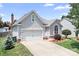 Charming home with a gray exterior, manicured landscaping, and an attached two-car garage at 141 Rose St, Mooresville, NC 28117
