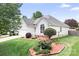 Charming single-story home with manicured lawn, beautiful landscaping and lovely curb appeal at 141 Rose St, Mooresville, NC 28117