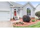 Charming front entrance with red door, white railings, flower beds, and well-kept landscaping at 141 Rose St, Mooresville, NC 28117