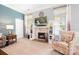 Cozy living room showcasing a fireplace, built-in shelving, and natural light from two windows at 141 Rose St, Mooresville, NC 28117