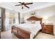 Spacious main bedroom featuring a tray ceiling, large bed, side tables, and natural light from the window at 141 Rose St, Mooresville, NC 28117
