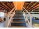 View of basement stairs with painted banister and open ceiling at 1410 Beverly Ave, Shelby, NC 28152