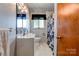 Well-lit bathroom featuring modern fixtures, a clean vanity, and a tiled shower at 1410 Beverly Ave, Shelby, NC 28152