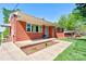 Charming brick home featuring a cozy front porch with a well-manicured lawn and landscaping at 1410 Beverly Ave, Shelby, NC 28152