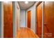 Hallway with hardwood floors, wood doors, and ample closet space at 1410 Beverly Ave, Shelby, NC 28152