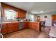 Well-lit kitchen with wood cabinets, stainless steel appliances, and a cozy dining area at 1410 Beverly Ave, Shelby, NC 28152