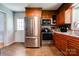Kitchen featuring stainless steel appliances, wood cabinets, and vinyl flooring at 1410 Beverly Ave, Shelby, NC 28152