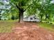 A charming one-story home with a covered front porch, surrounded by mature trees on a spacious lot at 14600 Glendale Dr, Huntersville, NC 28078