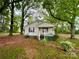 Charming single-story home featuring a covered porch and mature trees in a lush yard at 14600 Glendale Dr, Huntersville, NC 28078