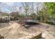 The backyard features a trampoline, an enclosed back porch, and a sandbox area to provide various activities to enjoy at 1620 Edgefield Ave, Gastonia, NC 28052