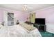 Cozy bedroom with white bedding, pink walls, and a ceiling fan at 1620 Edgefield Ave, Gastonia, NC 28052