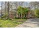 Charming brick home featuring a well-maintained lawn, mature trees, and inviting curb appeal at 1620 Edgefield Ave, Gastonia, NC 28052