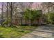 Quaint brick home with mature trees creating a serene environment; a welcoming entrance with a concrete driveway at 1620 Edgefield Ave, Gastonia, NC 28052