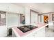 Bright kitchen with pink and white tiled countertops and vintage wallpaper at 1620 Edgefield Ave, Gastonia, NC 28052