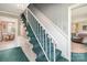 Interior stairway featuring carpeted steps and white railings leading to the upper level at 1620 Edgefield Ave, Gastonia, NC 28052